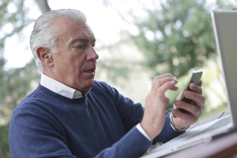 older man with phone